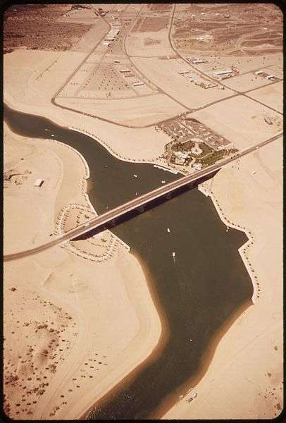 The bridge was assembled on dry land and a channel was cut beneath it, forming Lake Havasu Cityâs famous âIsland.â This aerial shot was taken in 1972, less than a year after the bridge was rededicated. (Wikipedia/Charles OâRear)