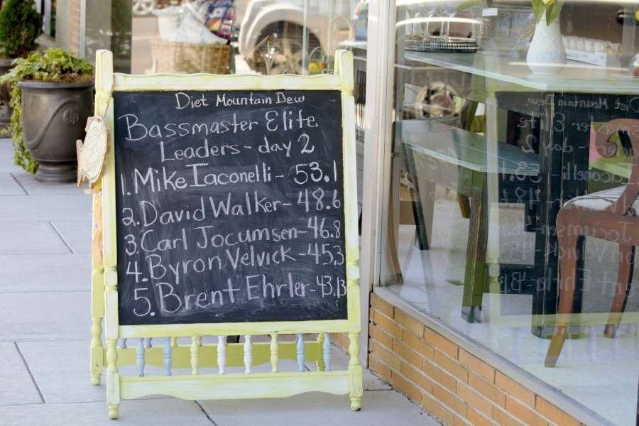 A chalkboard outside the antique store is updated with the daily leaders and their weights.