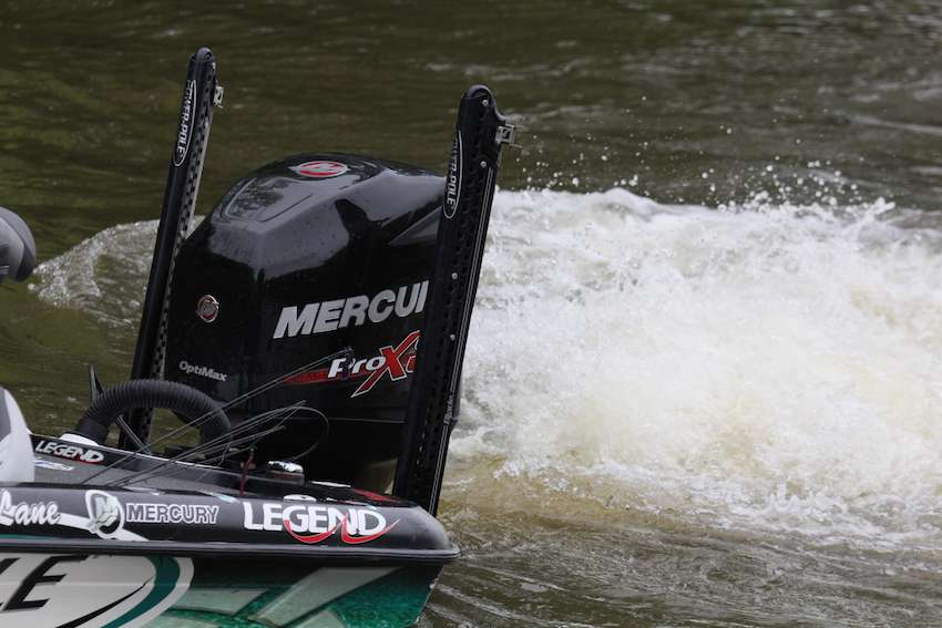 Chris Lane's co-angler helps load his boat. 