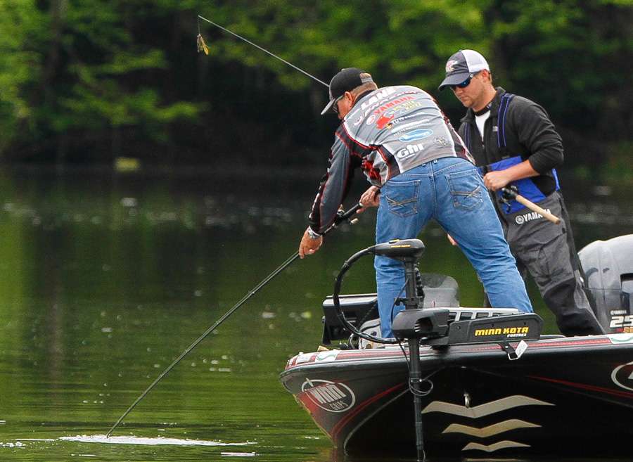 Lane dips his rod into the water to keep the fish from jumping again...