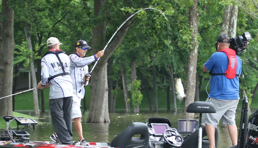 Evers swings the bass in his boat as it continues to battle him.