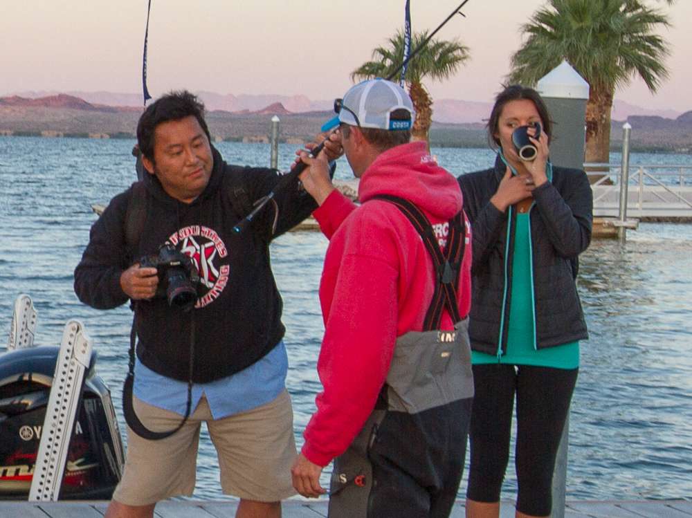 Photographer Seigo Saito helps position Casey Ashley's bait for some photos. 