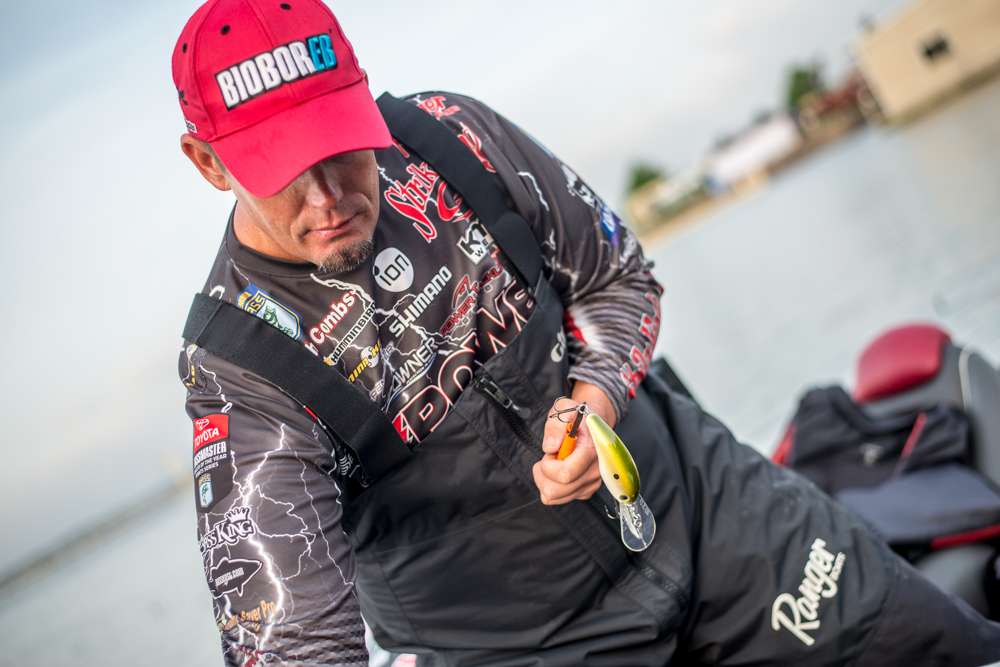 Keith Combs puts a fresh hook on his crankbait. 