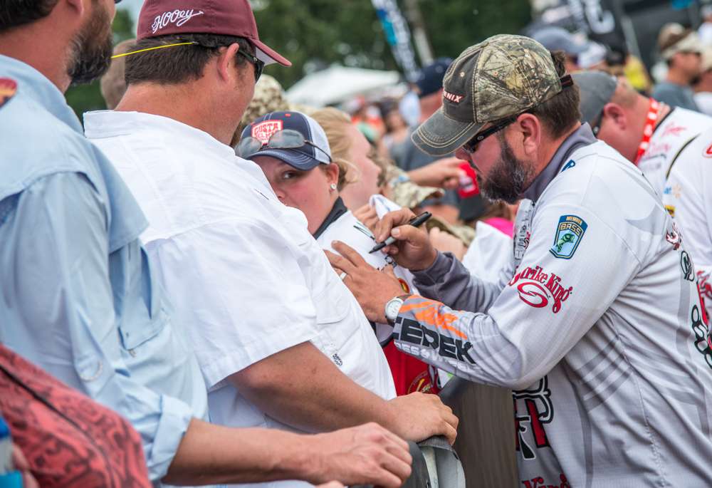 Hackney signs the fishing jersey of a dedicated fan.