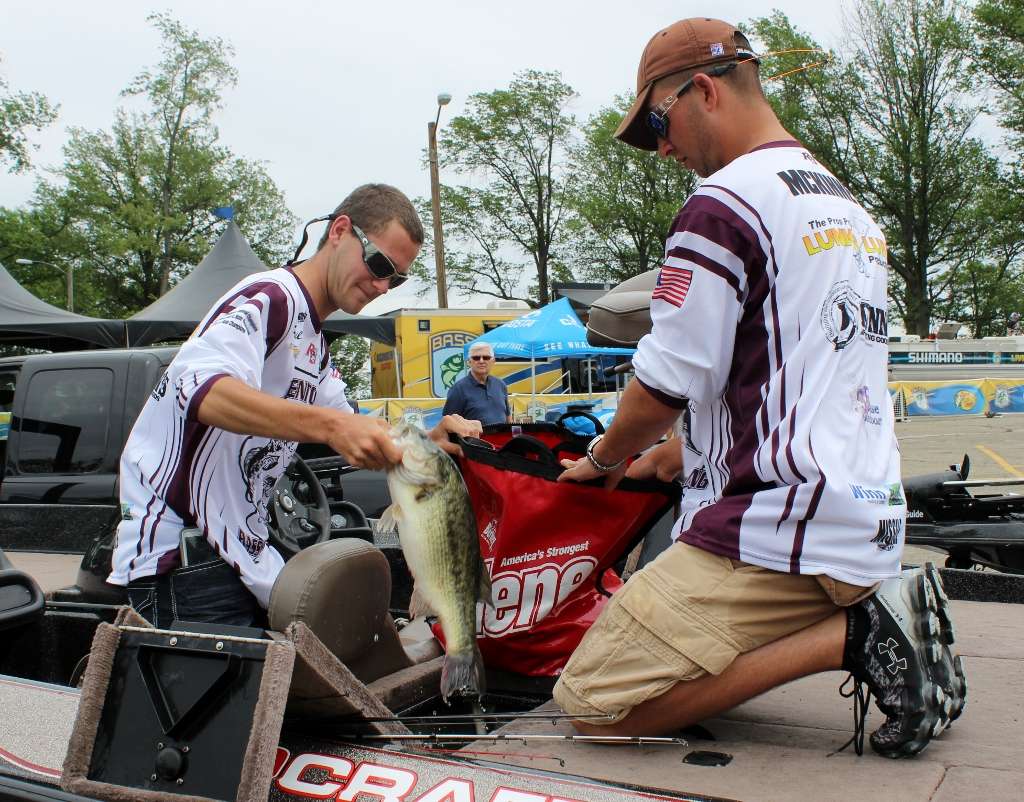Dailus Richardson and Trevor McKinney of Benton High School in Illinois place their fish in a weigh-in bag. This one weighed 5-2 and tied for big-fish honors.