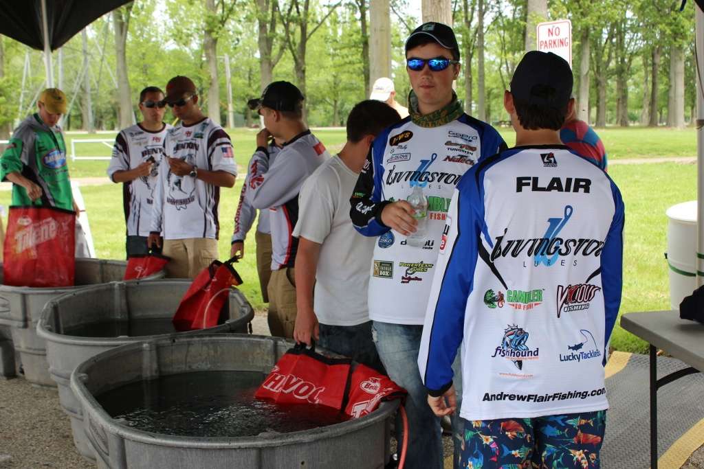 Anglers wait at the tanks for the weigh-in to begin.