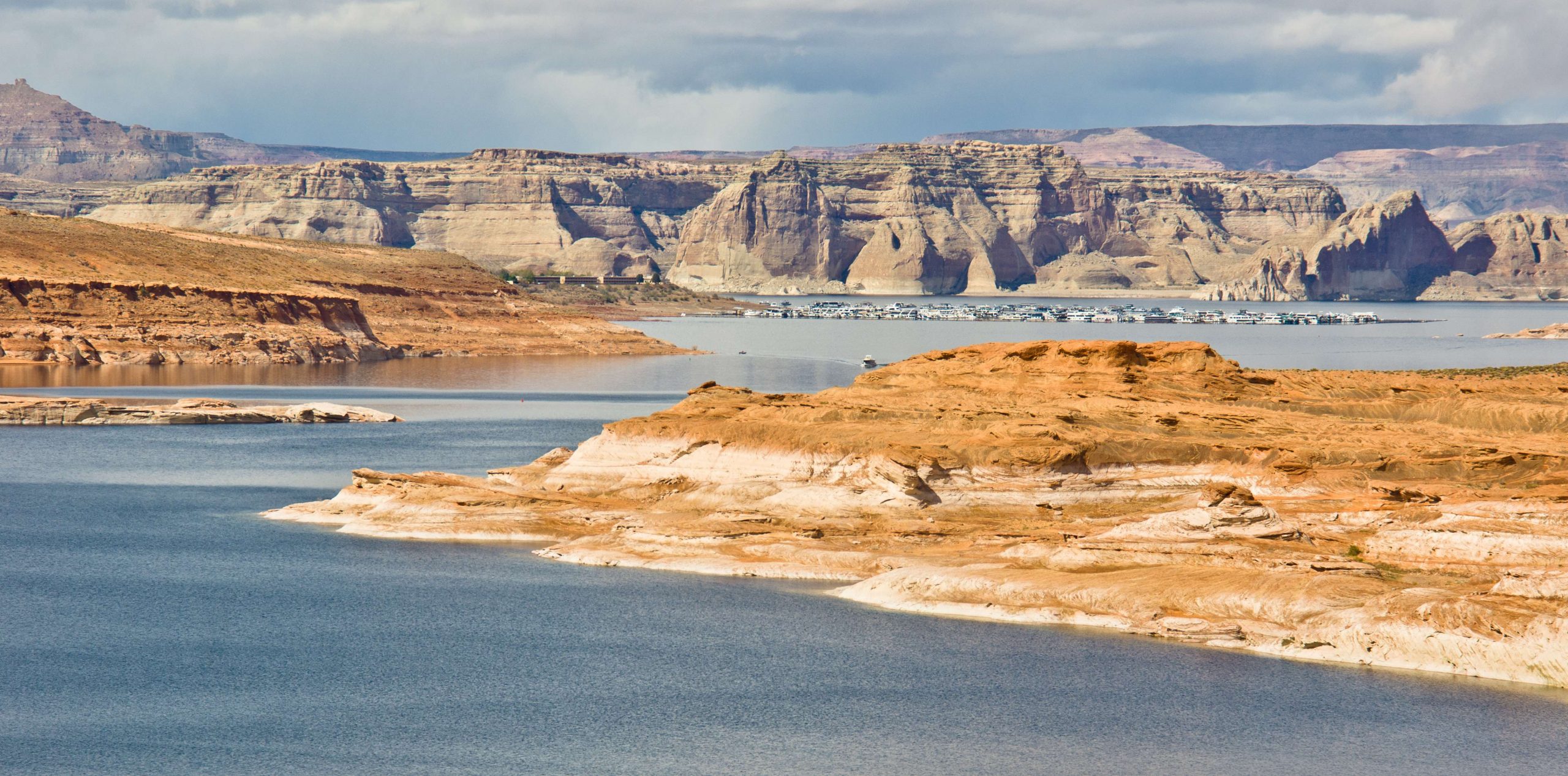 Lake Powell is a reservoir located on the Colorado River, and it straddles the Utah and Arizona state line. It is the second largest man-made reservoir by maximum water capacity in the U.S. behind Lake Mead.