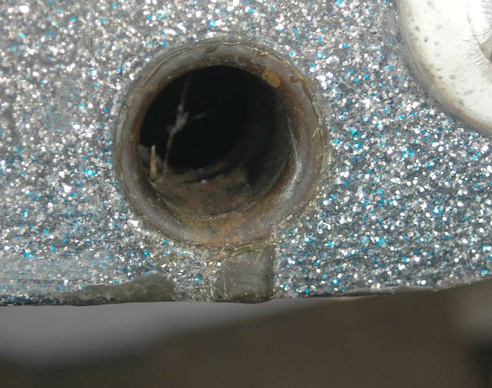 A gelcoat repair around the drain in the transom left an uneven surface in the running pad. It looks innocuous, but it will disrupt performance.