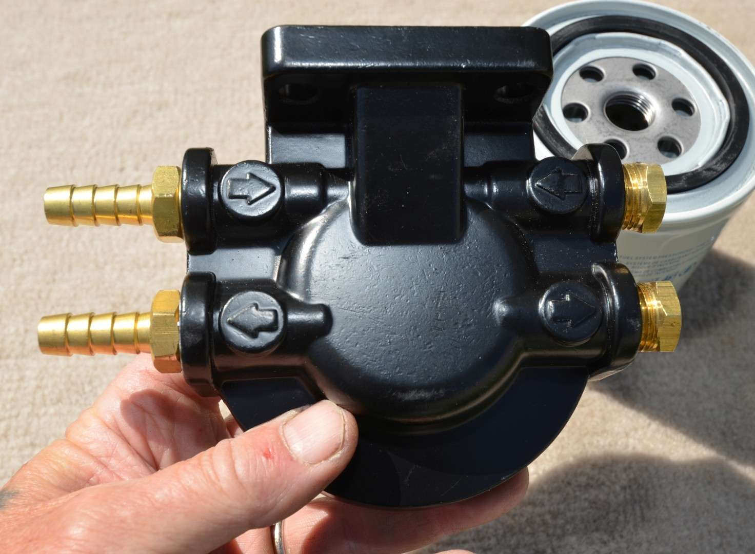 <em>INSTALLING A FUEL/WATER SEPARATOR</em>
<br>The fuel/water separator bracket lets you connect in/out fuel lines on opposite sides or on the same side. I did the latter.