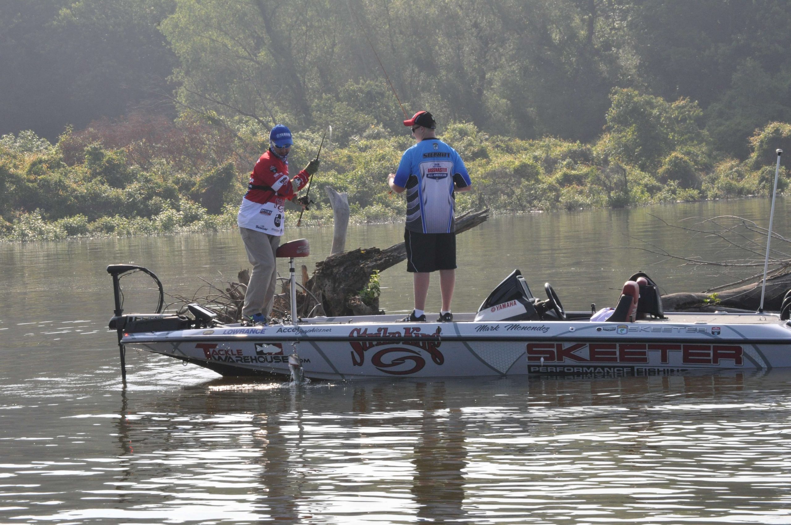 The focus pays off as Menendez sets the hook on a largemouth, then swings it aboard.