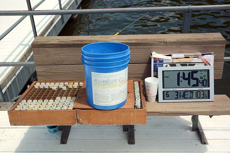 Essentials at the boat check in station is the box for the organized boat key fobs, a catch all bucket to hold them prior to sorting, and the all-important official time clock. 