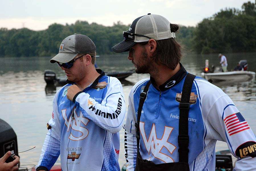 The Bassmasters TV crew attaches wireless microphones on Josua Butts and Justin Rivers. 