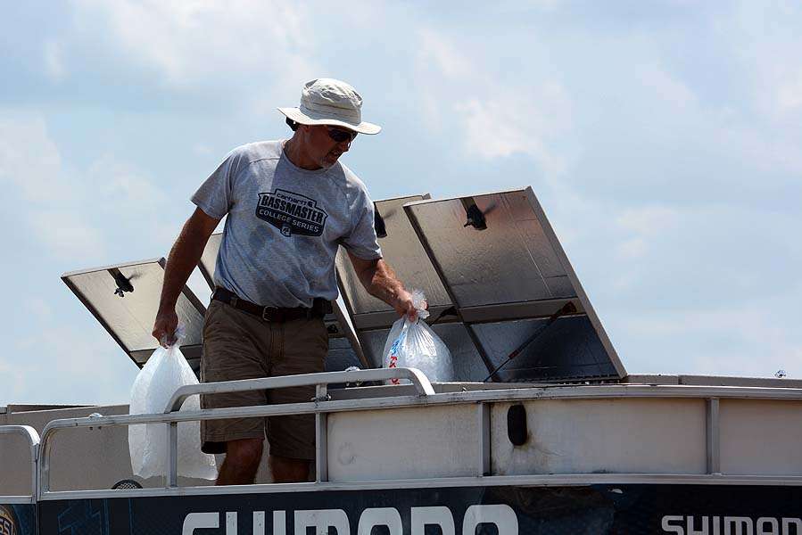Ice bags are emptied into the tanks aboard the live release boat. The ice is used to slightly lower the water temperature to keep bass healthy until release back into Ross Barnett.