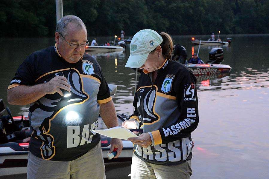 Alan Pierce and Lisa Talmadge check the boat list.