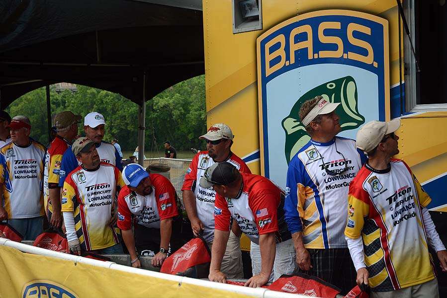 The anglers eye the video scoreboard as the weigh-in unfolds for the final day. 