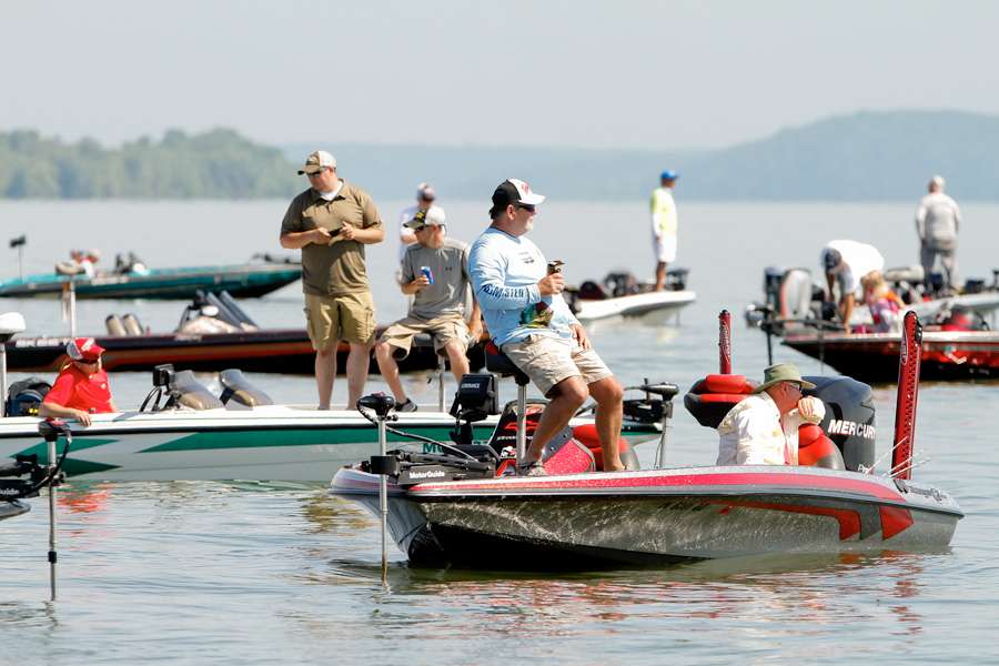 â¦with several spectator boats watching him fish. 