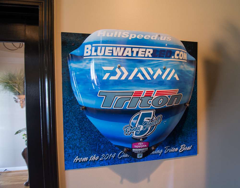 Next to the cabinet is the windshield that was on his boat when he won the 2014 Bassmaster Classic. He didn't keep the whole boat, but he kept this part of it to remind him of his victory.