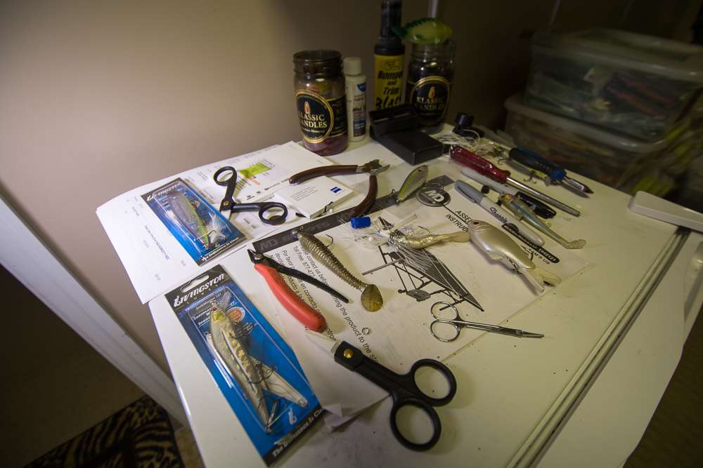 Tools and lures rest on top of a mini fridge.
