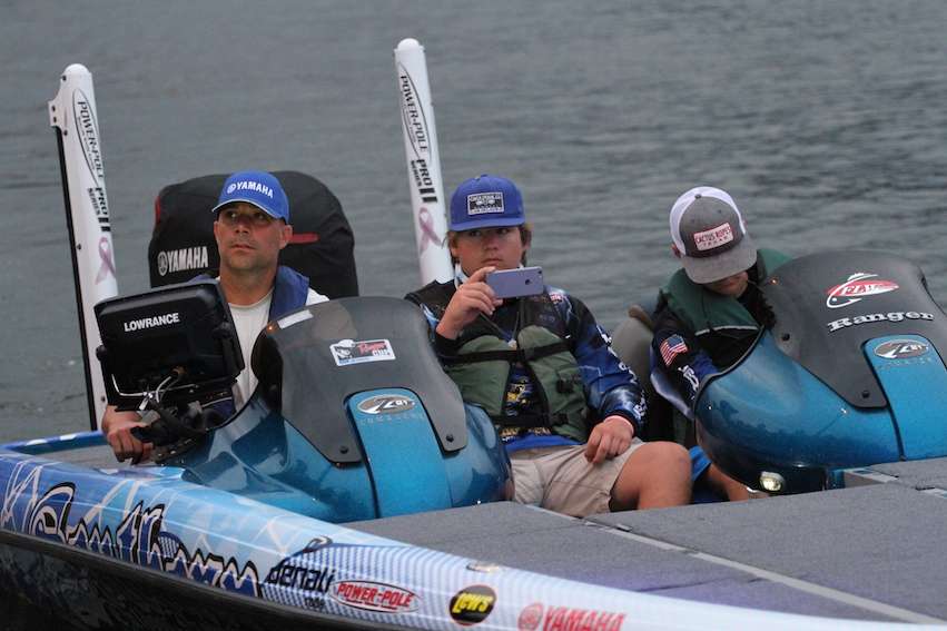 Anglers take the opportunity to take photos and videos while they head through the line.