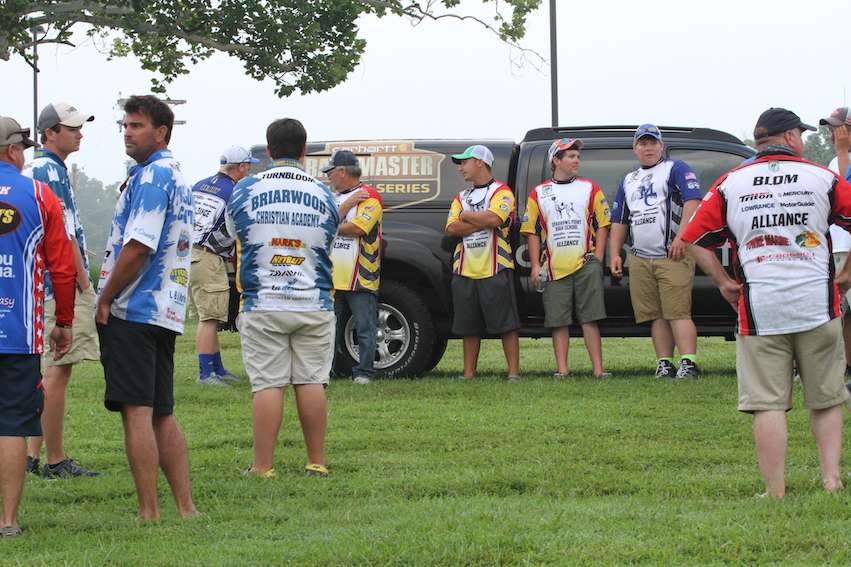 The High School teams meet by the Carhartt Bassmaster Tacoma for a briefing on how their big fish format will work today.