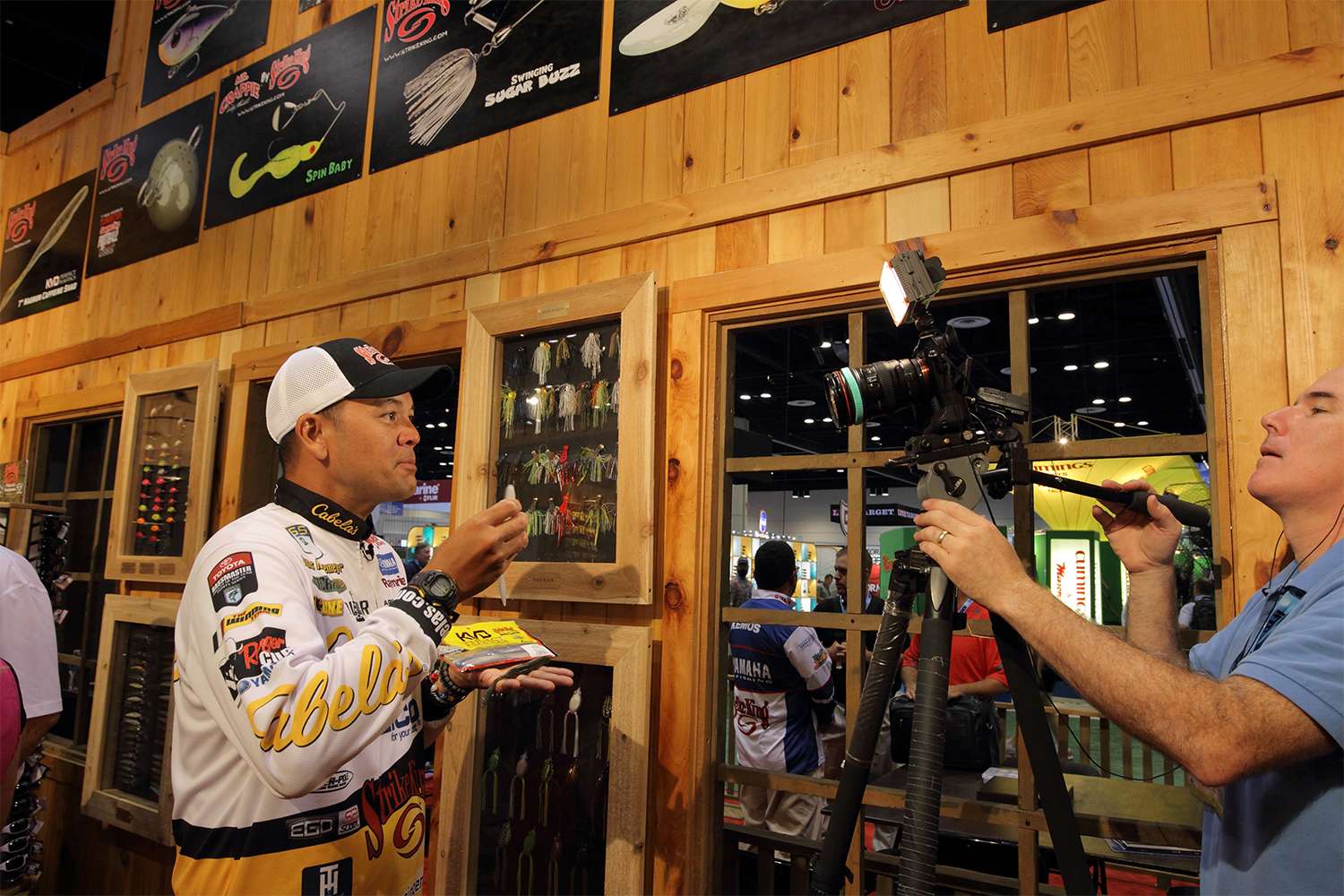 James Niggemeyer films at a busy Strike King booth.