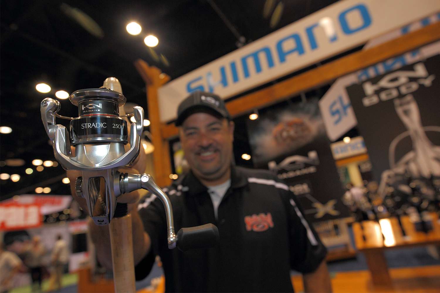 Mark Zona holds the Best of Show Stradic reel at Shimano.