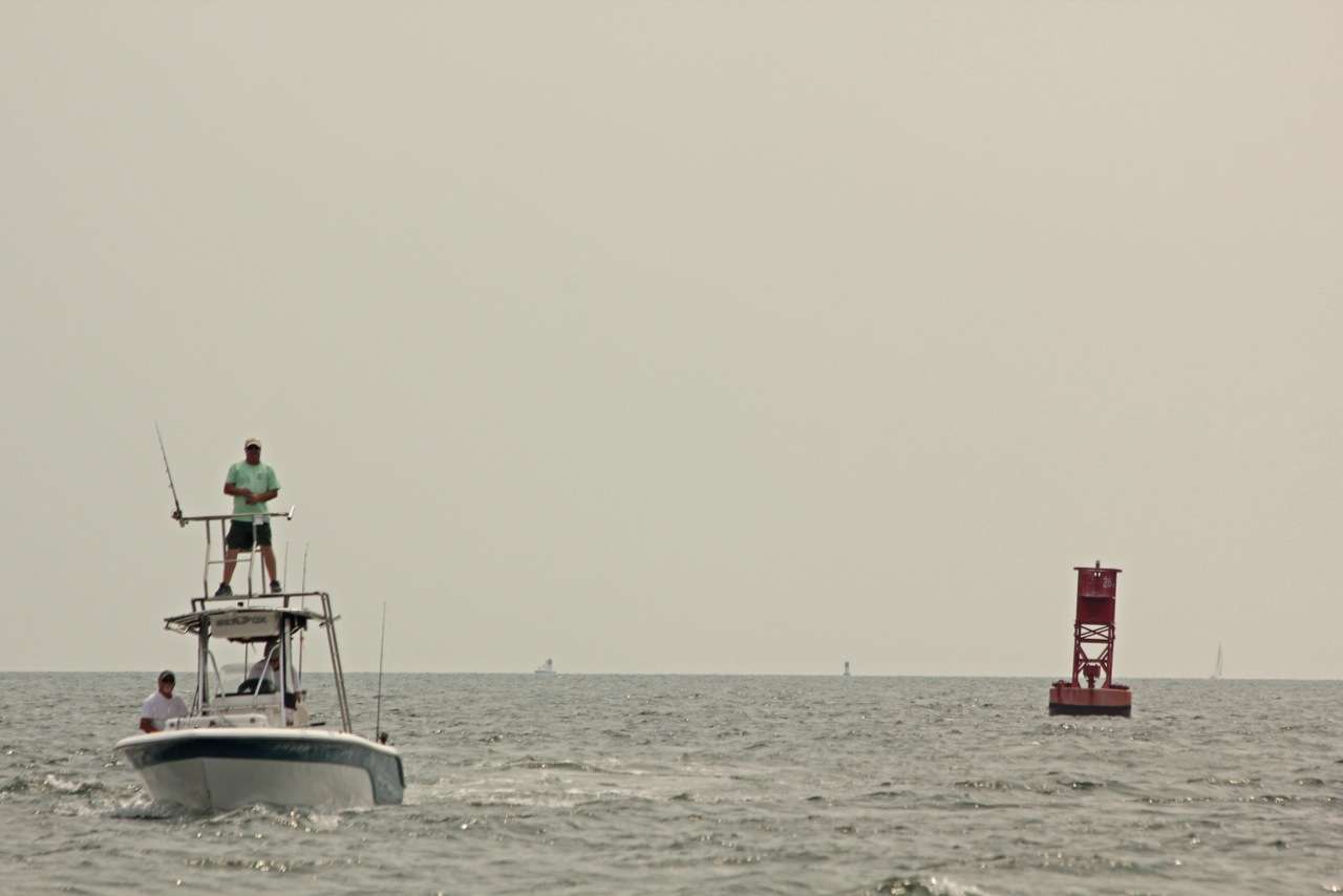 Another boat circles a âcanâ in search of Cobia.