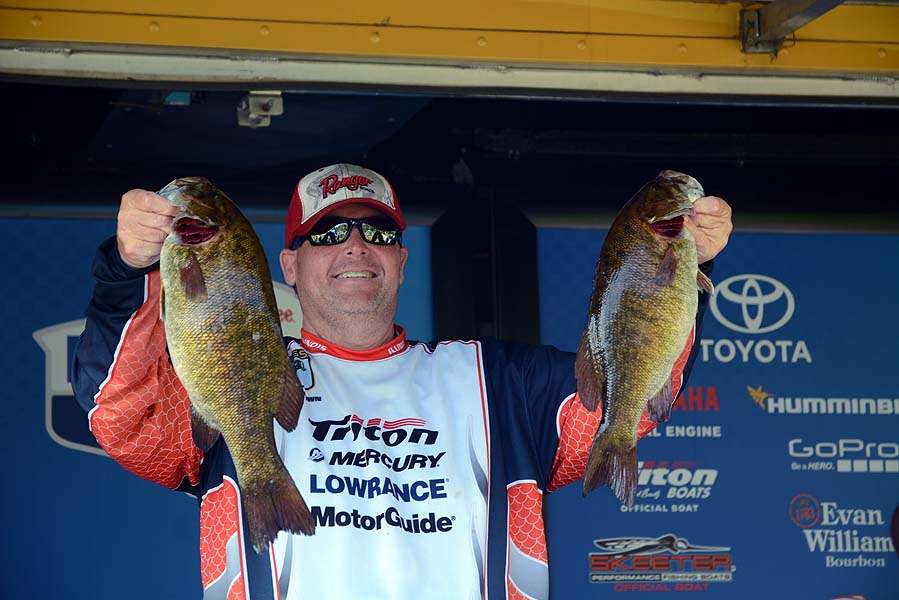 Dan Brown holds a pair of smallmouth putting him into third place after Day 1 with 15-15. 