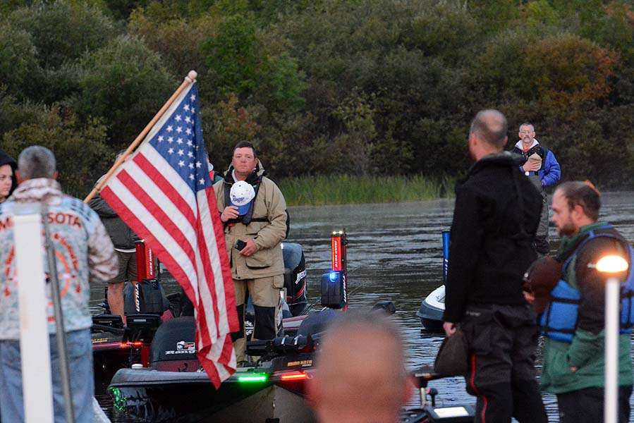 While the anglers honor the American flag. 