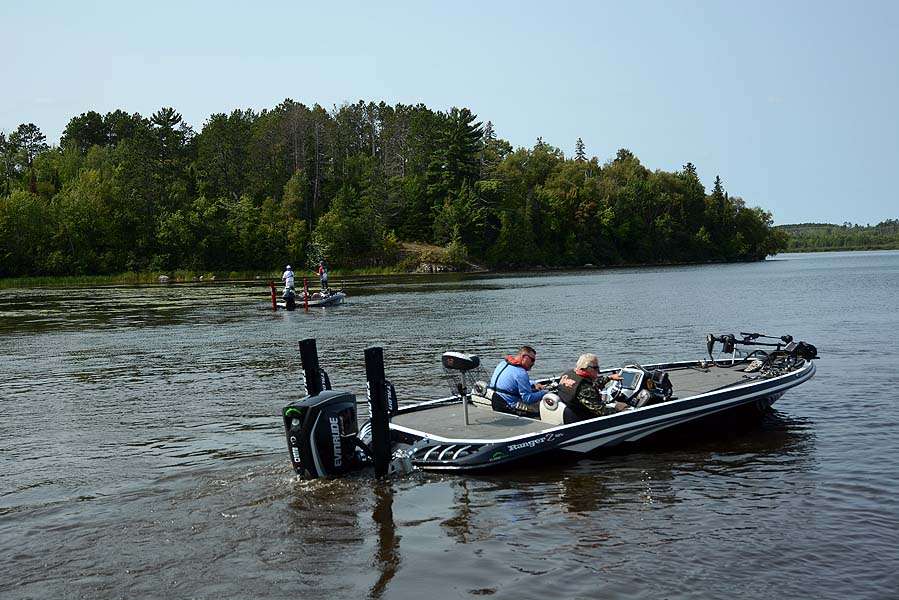 One boat idles to the check-in station while two anglers squeeze in a few last casts prior to the Day 2 weigh-in at Fortune Bay Marina.