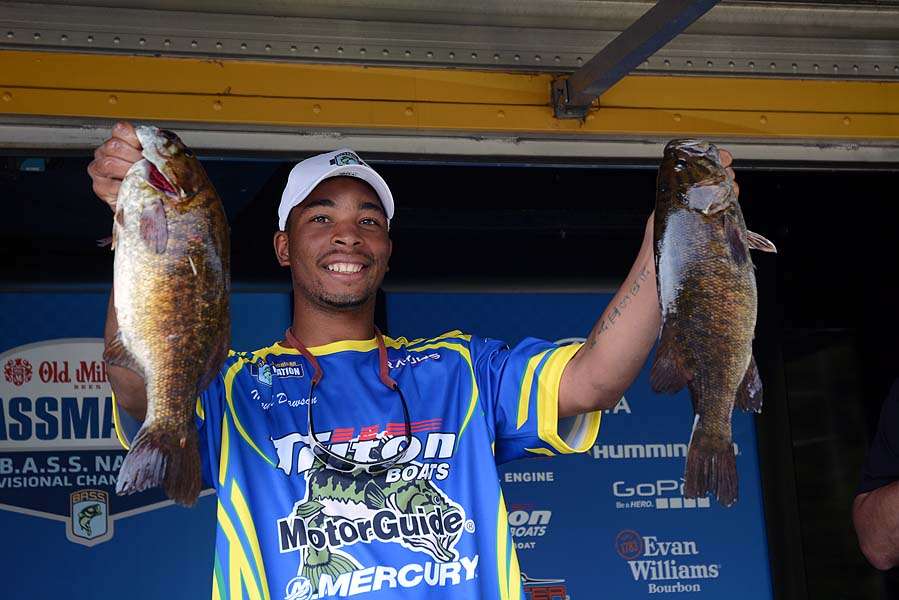 Miquel Dawson of Michigan holds a pair of bass from a personal best day. His 18-3 catch stands as the biggest so far of the tournament.