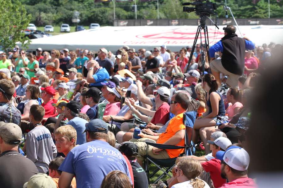 Fans are intent on watching the anglers bring their fish across the stage.