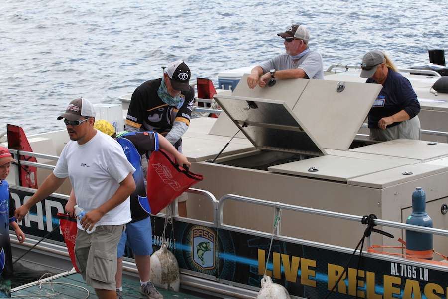 Officials work to return the day's catch to the St. Lawrence River by way of the Shimano Live Release boat.
