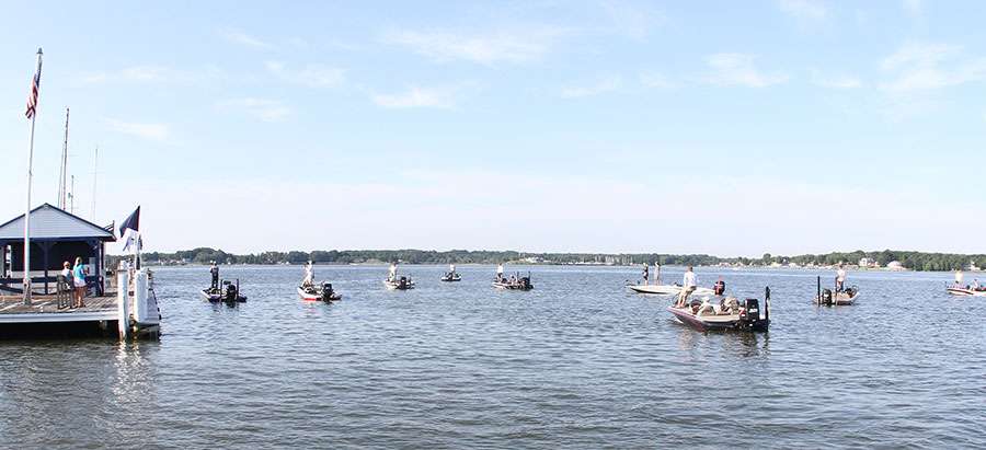 A flotilla of more than a dozen boats watched from outside the marina.