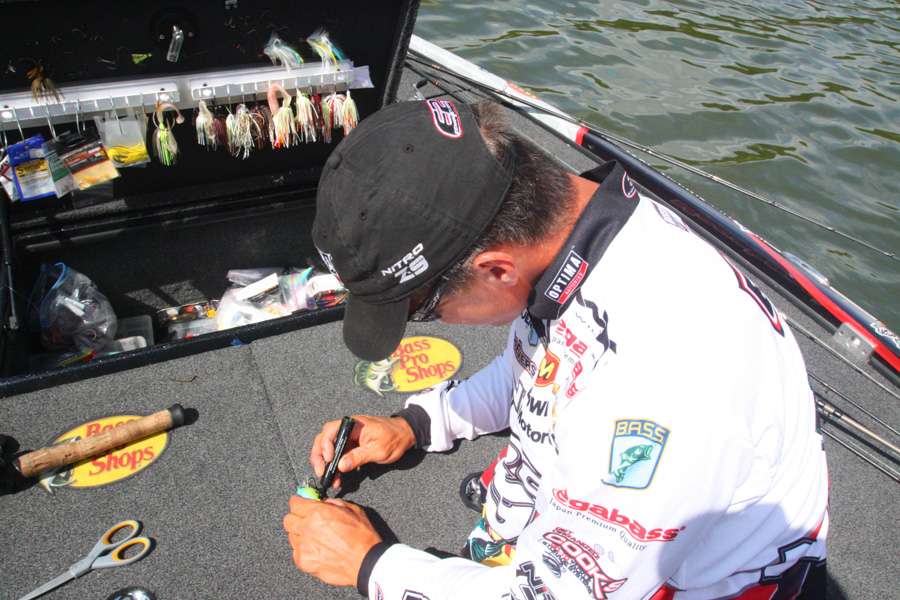 11:01 a.m. Evers repaints one of his square bill crankbaits with a waterproof marker to make it look more âbluegill-y.â
