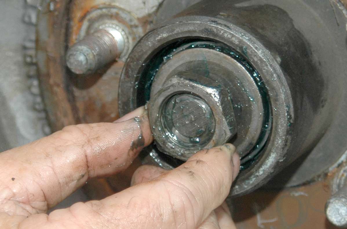 Slide the hub back onto the axle. Place the outside bearing on the axle so it rests against its race, followed by the big washer and the nut. Tighten the nut until it stops. Then back off one notch if you have a castle nut. Do not over-tighten. The hub should make one or two rotations when you spin it.
