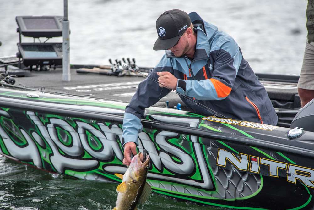 VanDam lifts the fish into the boat. 
