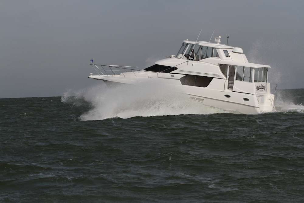 A big cruiser yacht stirs up the waves even more.