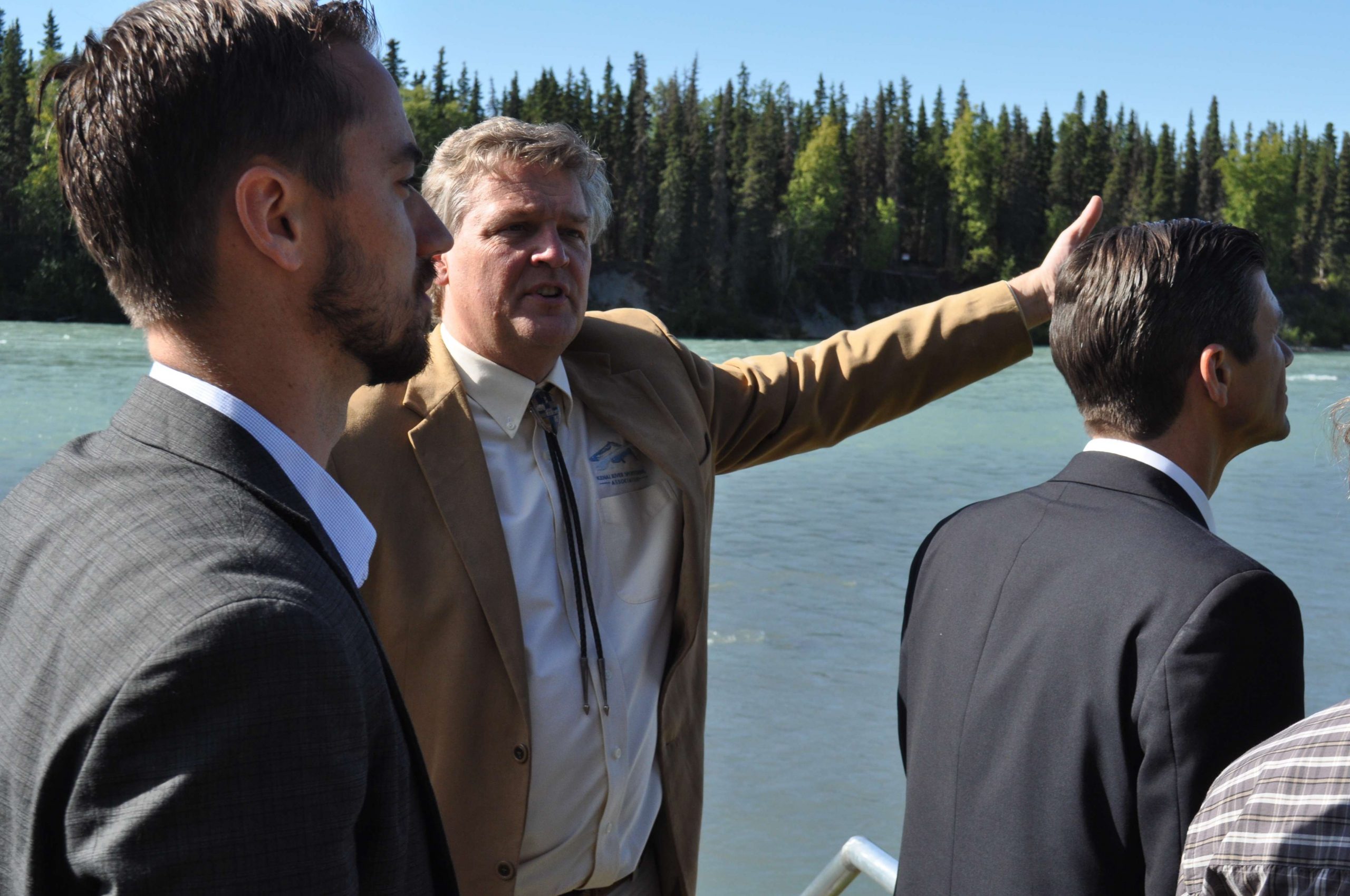 Ricky Gease (center), executive director of the Kenai River Sportfishing Association, shows off a conservation project along the Kenai River that was funded by the Kenai River Classic tournament.