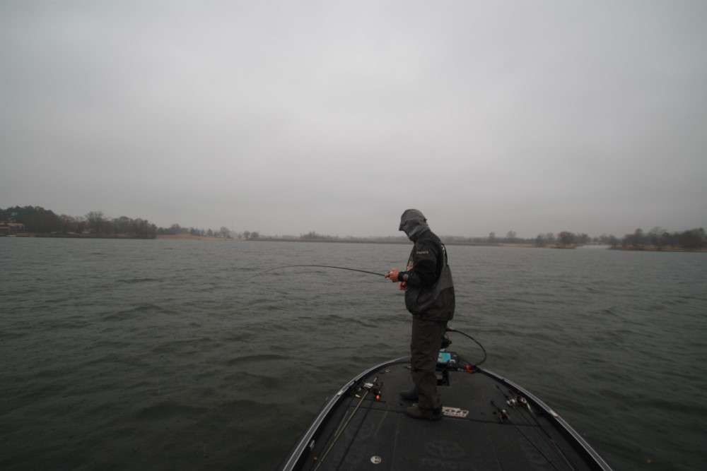 8:40 a.m. As rain sweeps across Lake P, Swindle battles a giant bass that hit his jerkbait on a submerged rockpile.