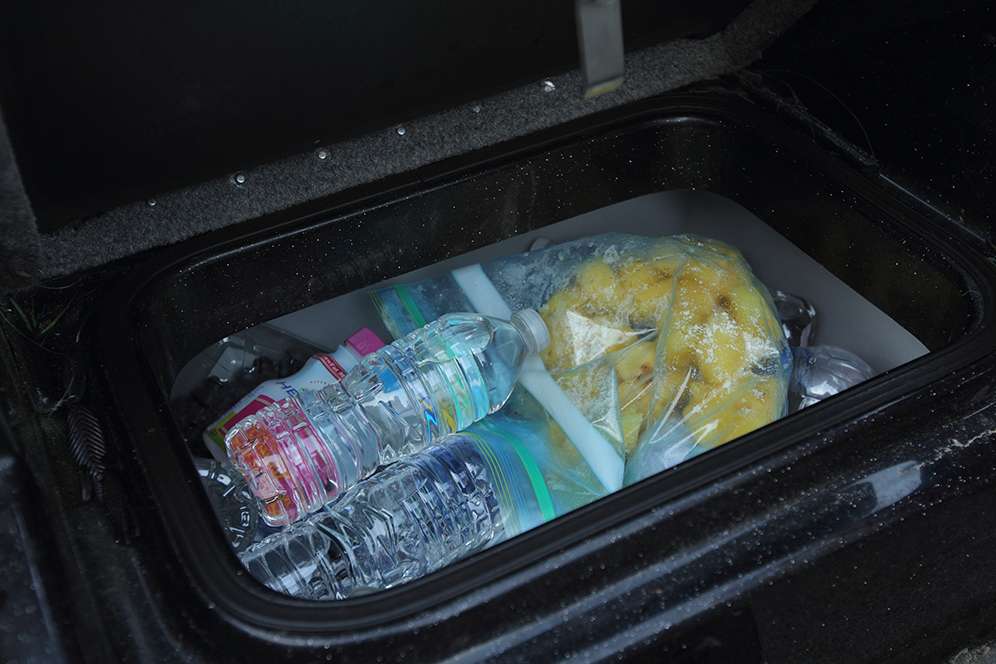 His cooler is loaded down with ice, water and snacks.