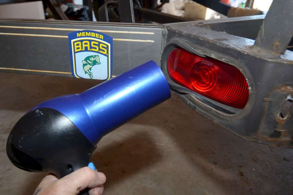 I used a hair dryer to heat and soften the rubber casings around the inset, waterproof tail lights. This helped me work them out. I left the reflectors in place and covered them with masking tape.