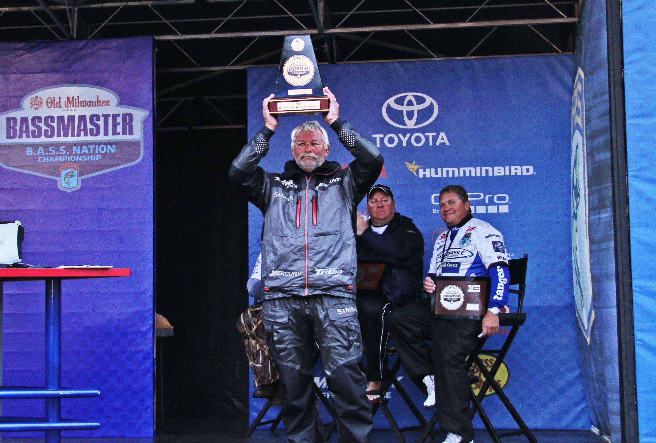 Albert Collins of Nacogdoches, Texas, hoists the 2015 B.A.S.S. Nation Championship trophy over his head. The victory earned him an invitation to fish the 2016 Bassmaster Elite Series, and by winning the Central Division, he earned a berth to the Bassmaster Classic in March 2016.