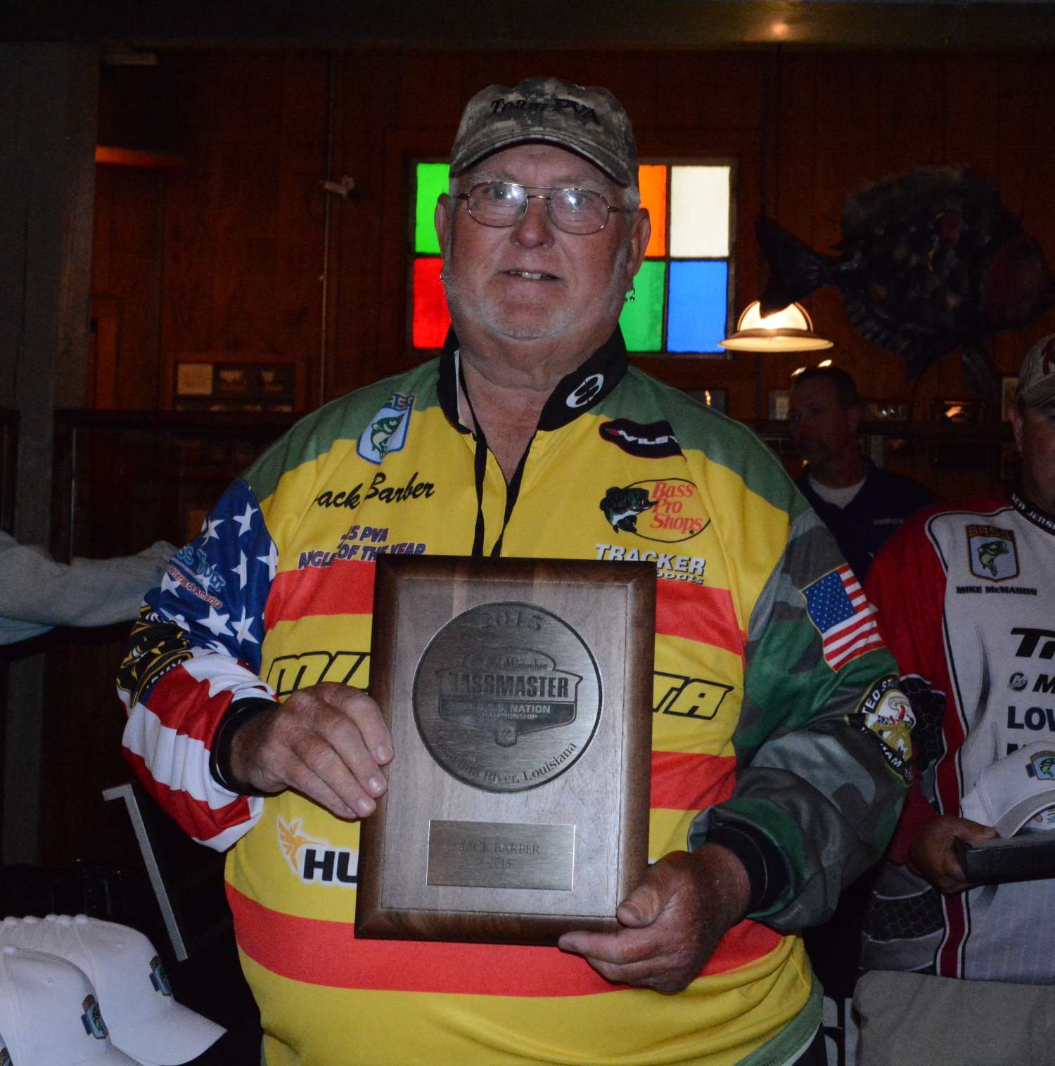 Jack Barber of Texas shows off another of the gifts, which is the plaque every competitor receives for qualifying. Barber qualified through the Paralyzed Veterans of America Tour, and he's proud to be sporting a jersey that displays the colors of Vietnam veterans.
