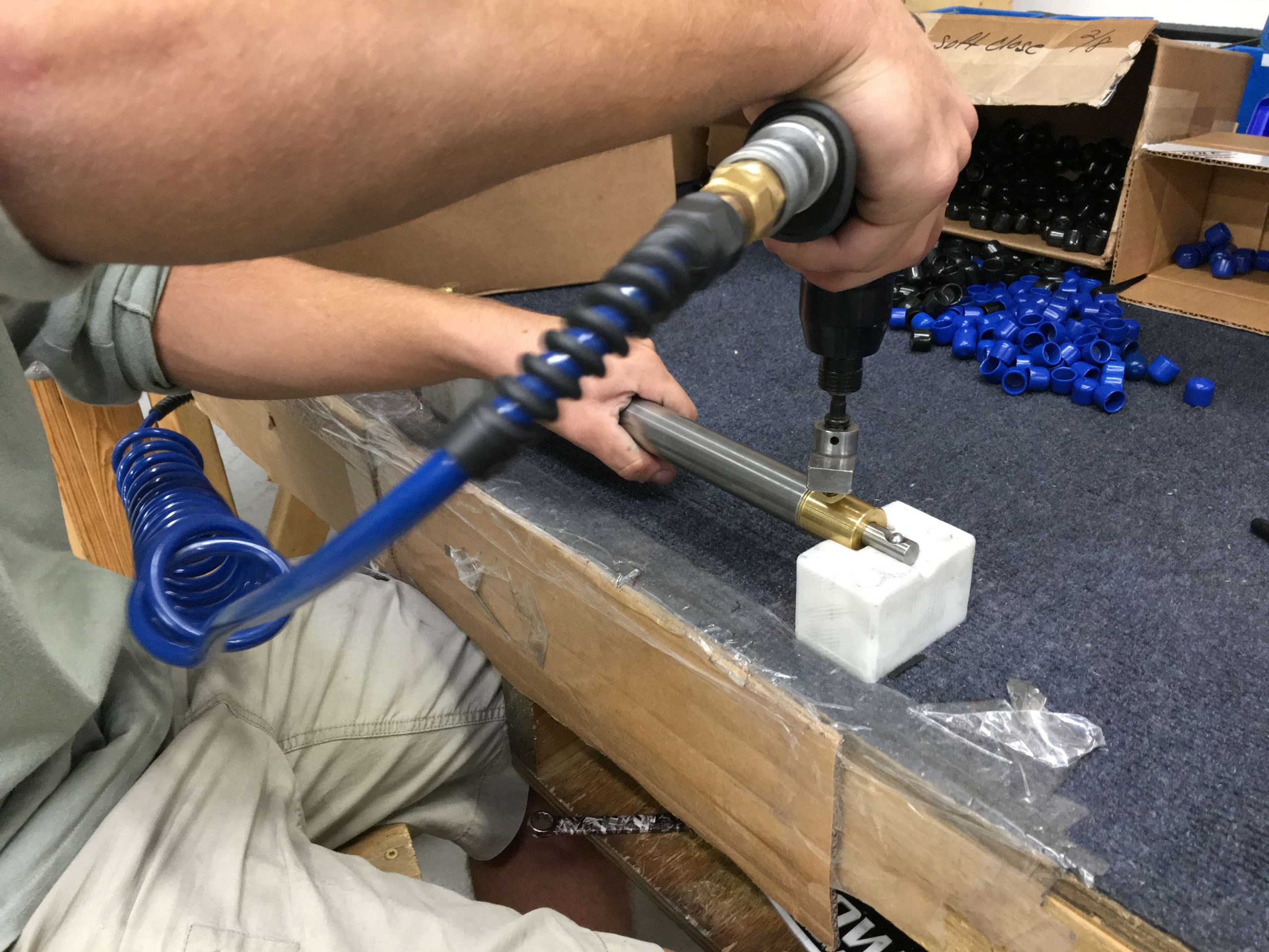 This worker is testing and attaching the fittings to the hydraulic cylinders that help the Power-Pole to extend and retract, in and out of the water.