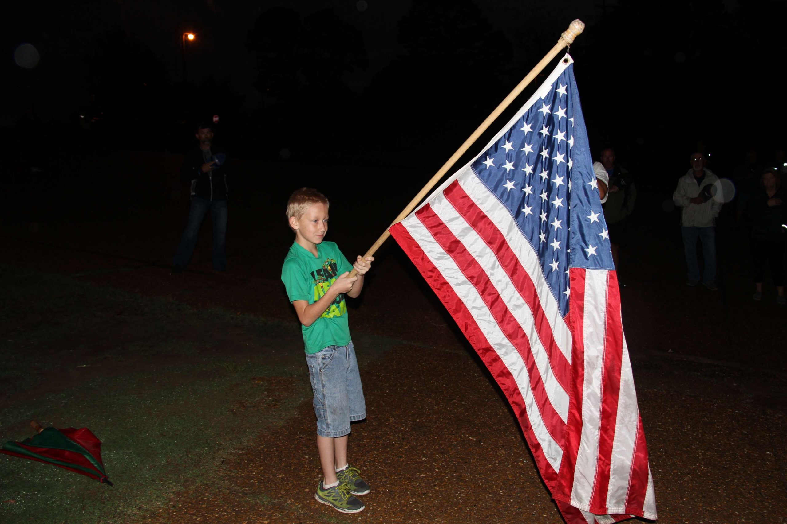 Nathan King, 8, of West Monroe, La., has the honor of holding the flag during the National Anthem on the second day.