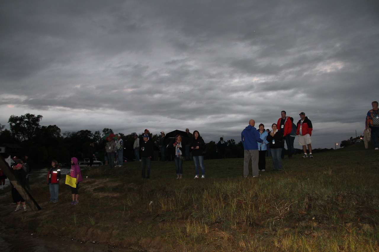 Friends and family look on as the anglers head off under ominous skies.