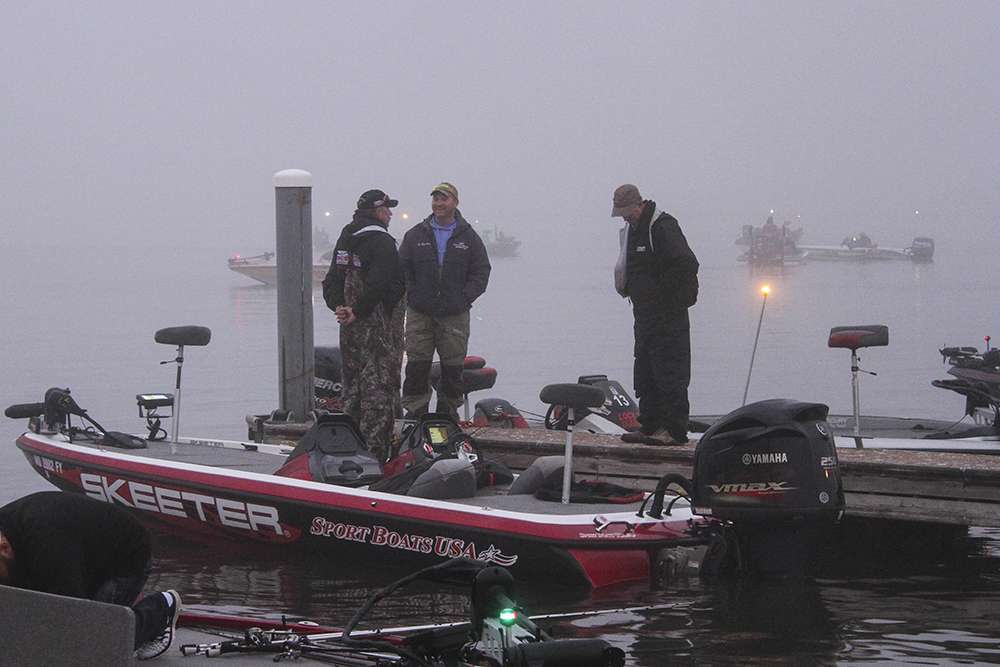 Teams gather on a dock to talk while they wait for the fog to lift...