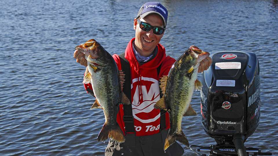 Former college angler Austin Felix holds up his two biggest fish from Friday.