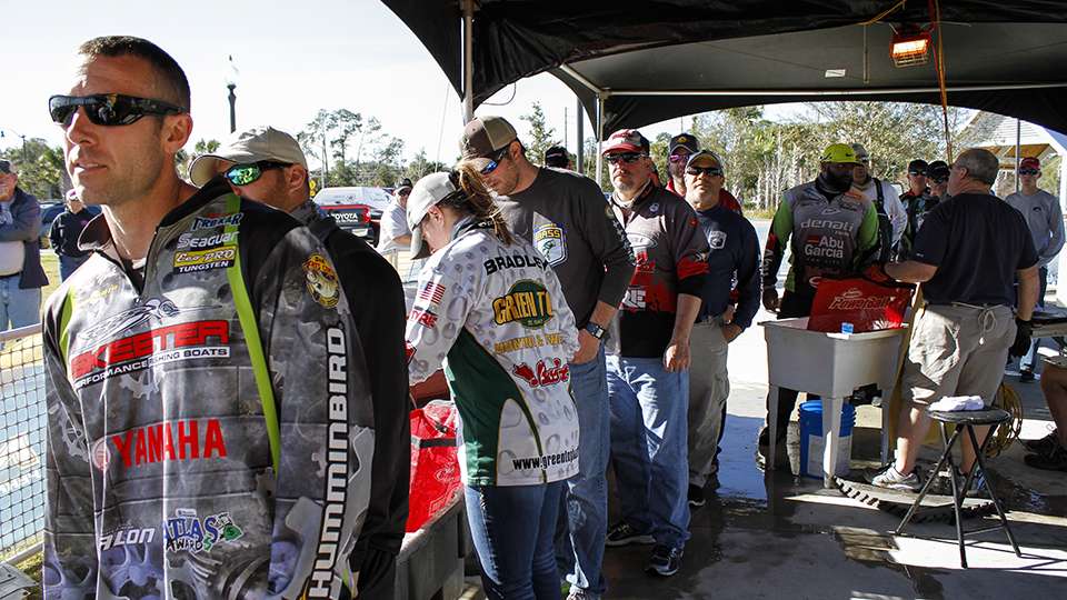 Fishermen and women gather backstage before they head to the scales and weigh their catch.